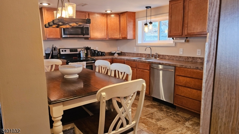 12 Ford Road Landing, NJ 07850 - Photo 6 of 32 a kitchen with stainless steel appliances granite countertop a sink a stove a microwave a sink and cabinets