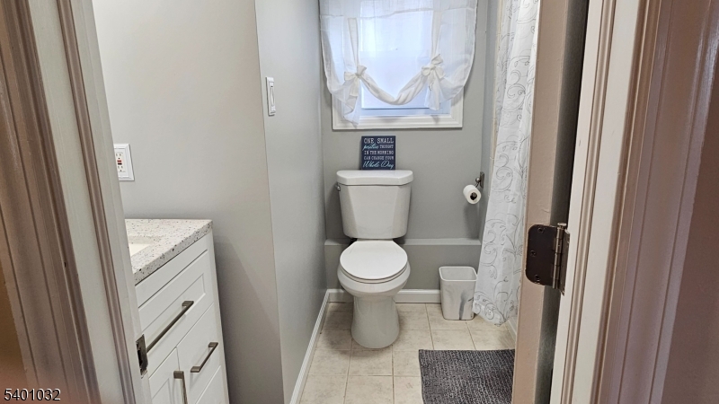 12 Ford Road Landing, NJ 07850 - Photo 10 of 32 a white toilet sitting next to a bathroom sink