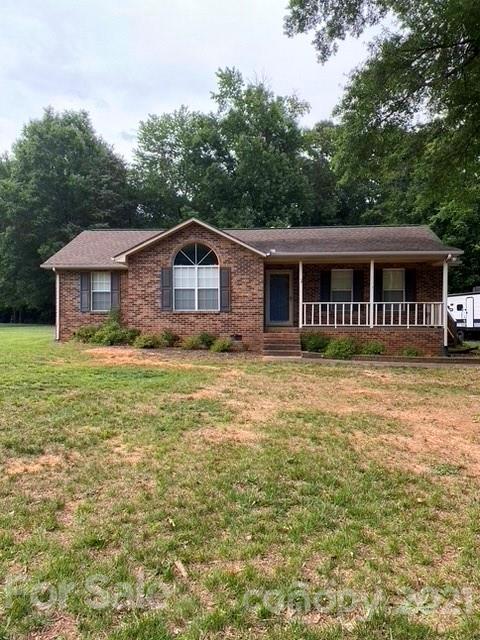 409 Chaney Road Monroe, NC 28110 - Photo 1 of 23 a front view of a house with a garden