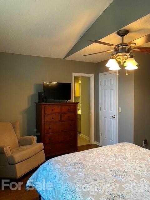 409 Chaney Road Monroe, NC 28110 - Photo 14 of 23 a bedroom with a bed and a chandelier