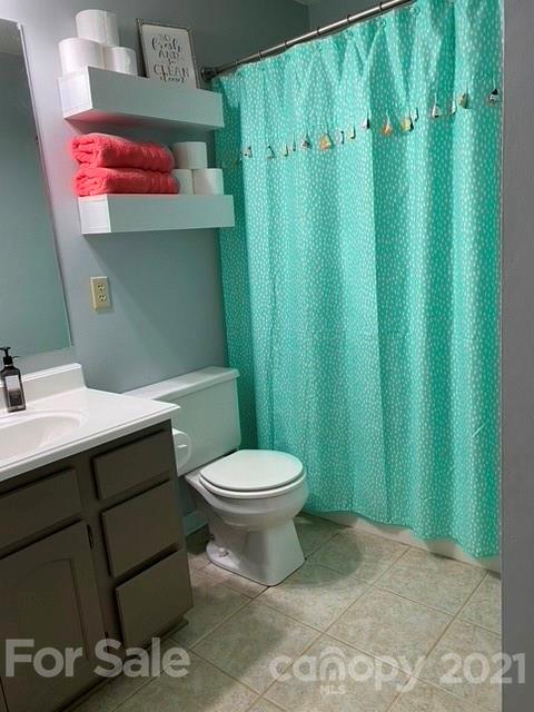 409 Chaney Road Monroe, NC 28110 - Photo 16 of 23 a bathroom with a toilet sink and curtain
