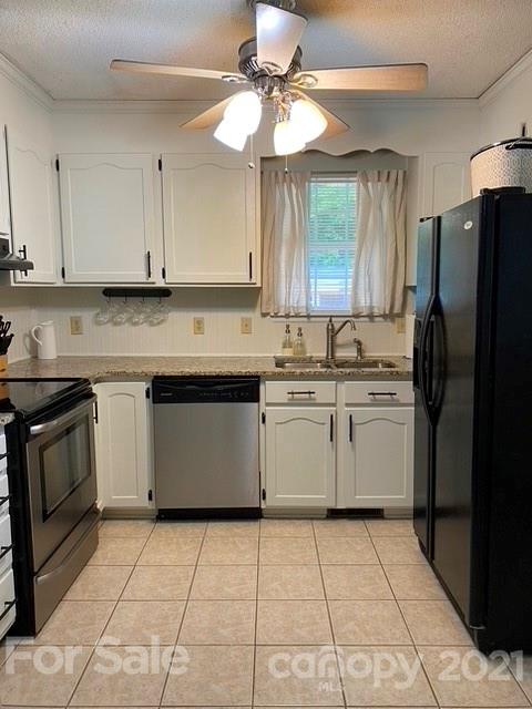 409 Chaney Road Monroe, NC 28110 - Photo 18 of 23 a kitchen with a stove sink and refrigerator