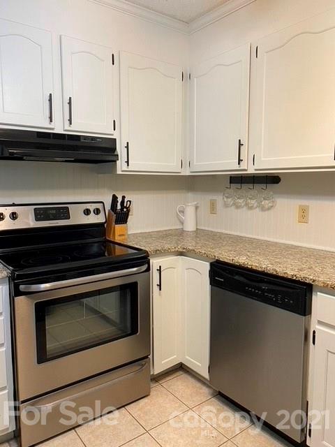 409 Chaney Road Monroe, NC 28110 - Photo 20 of 23 a kitchen with granite countertop white cabinets and stainless steel appliances