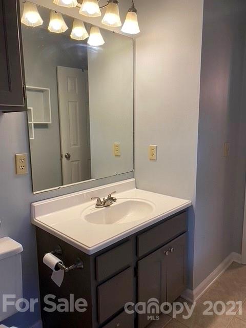 409 Chaney Road Monroe, NC 28110 - Photo 23 of 23 a bathroom with a sink and a mirror
