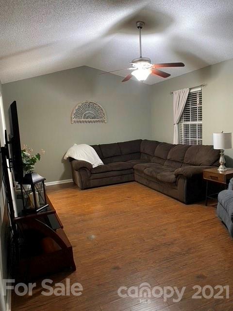 409 Chaney Road Monroe, NC 28110 - Photo 8 of 23 a living room with furniture and a flat screen tv