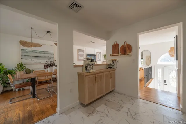 a kitchen with cabinets and wooden floor
