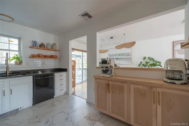 a kitchen with stainless steel appliances granite countertop a sink and a stove
