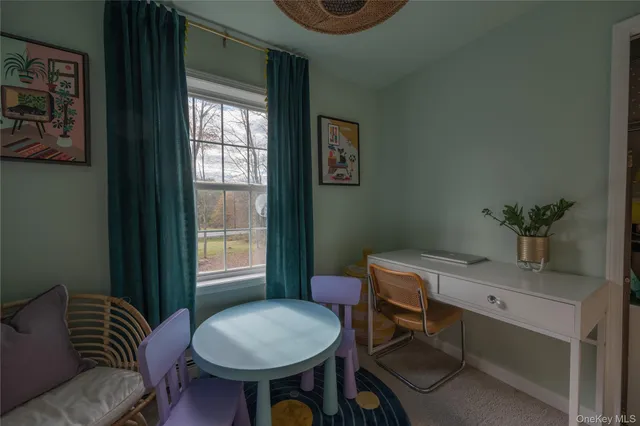 a view of a livingroom with furniture and window