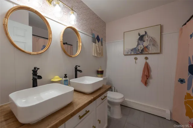 a bathroom with a toilet a sink and a mirror