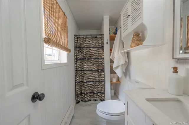 a bathroom with a toilet a sink and a shower