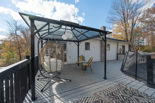 a view of a patio with table and chairs under an umbrella