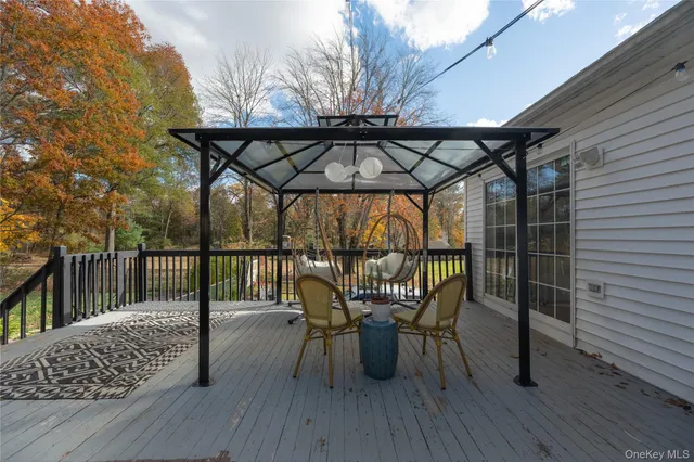 a view of balcony with wooden floor and outdoor seating