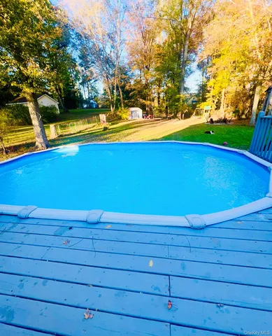 a view of a swimming pool with an outdoor space and seating area