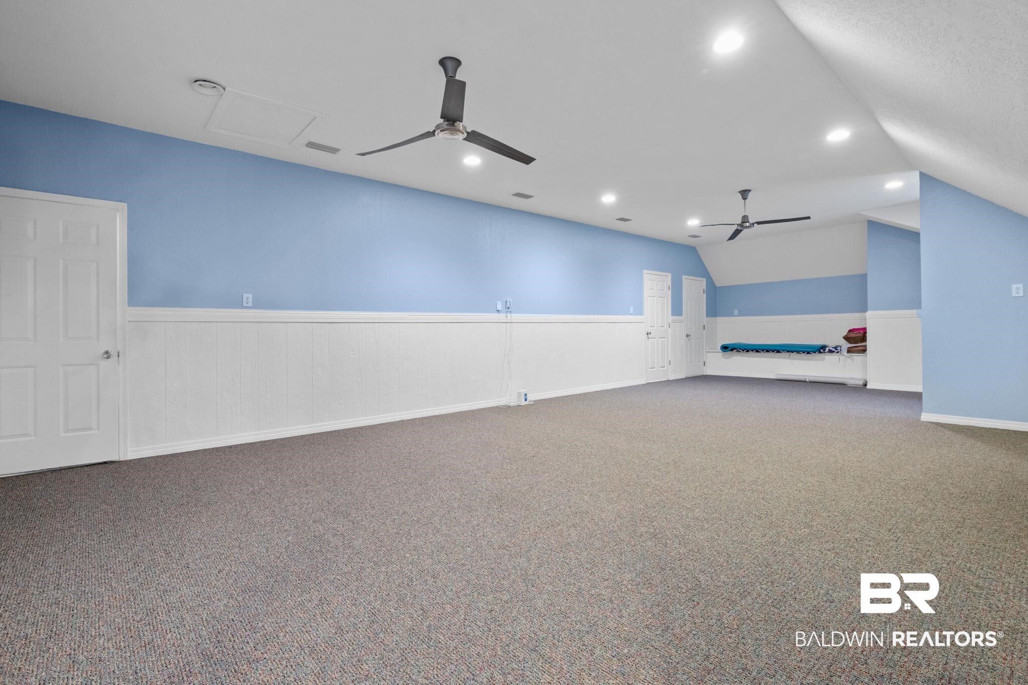 4771 Pecan Ridge East Mobile, AL 36619 - Photo 45 of 48 Empty room featuring ceiling fan, carpet floors, recessed lighting, vaulted ceiling, and a wainscoted wall