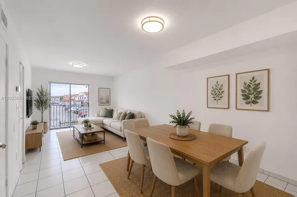 a living room with furniture a table and a potted plant