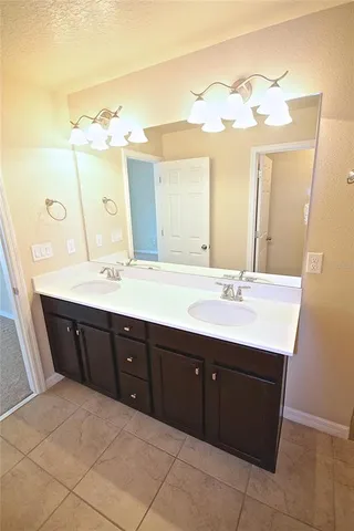 a spacious bathroom with a double vanity sink mirror and
