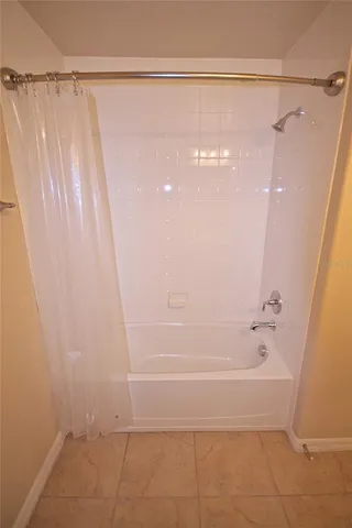a bathroom with a shower and a bath tub