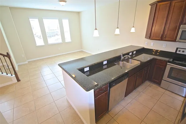 a kitchen with a sink appliances and cabinets