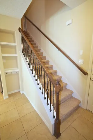 a view of staircase with white walls and a window