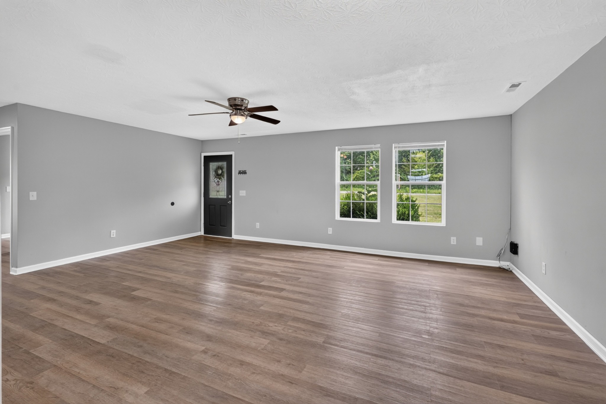 120 Driver Road Lafayette, TN 37083 - Photo 10 of 39 a view of an empty room with a window and wooden floor
