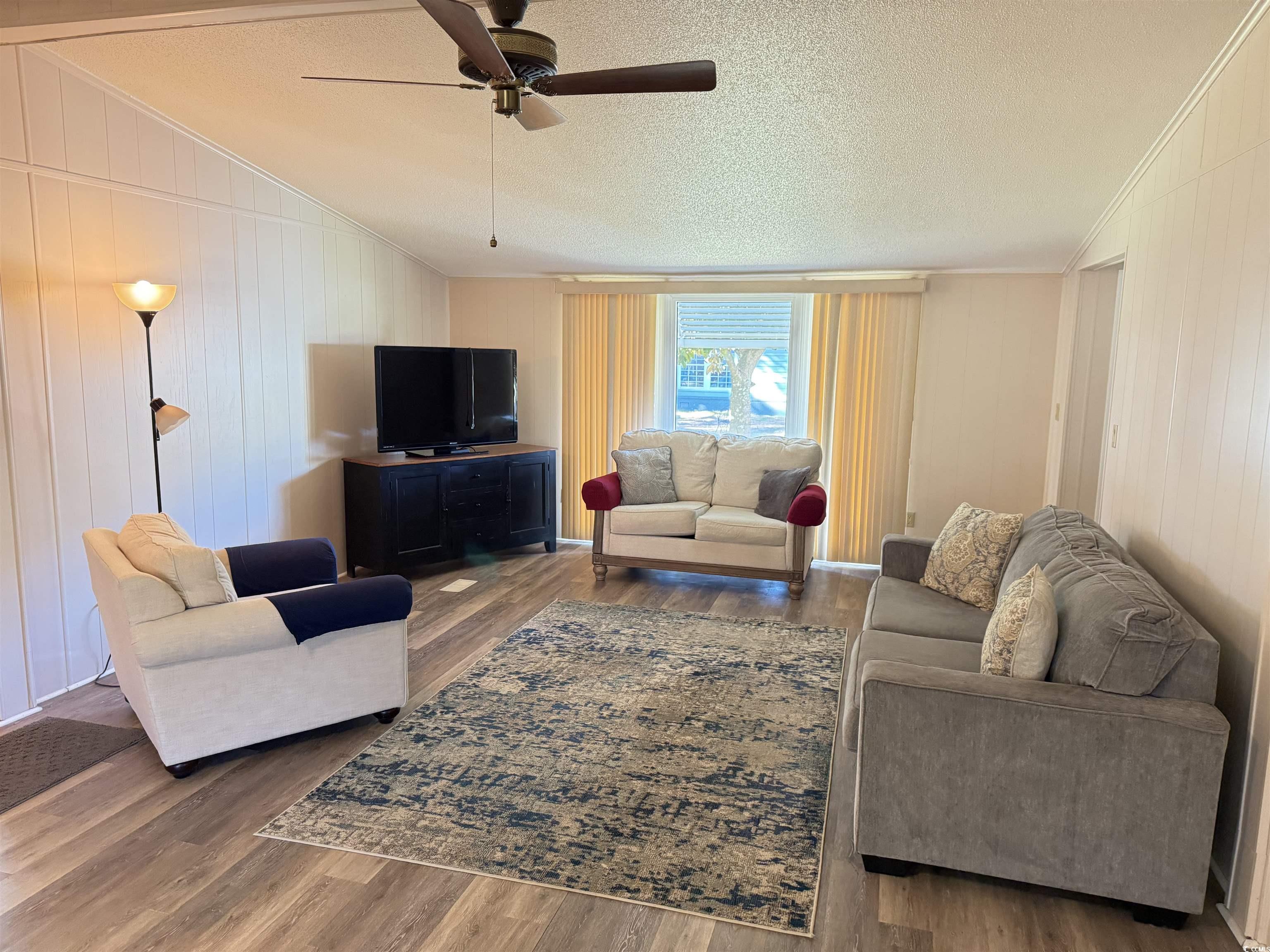 3255 Pecan Trail Murrells Inlet, SC 29576 - Photo 14 of 35 Living room featuring wooden walls, wood-type floo