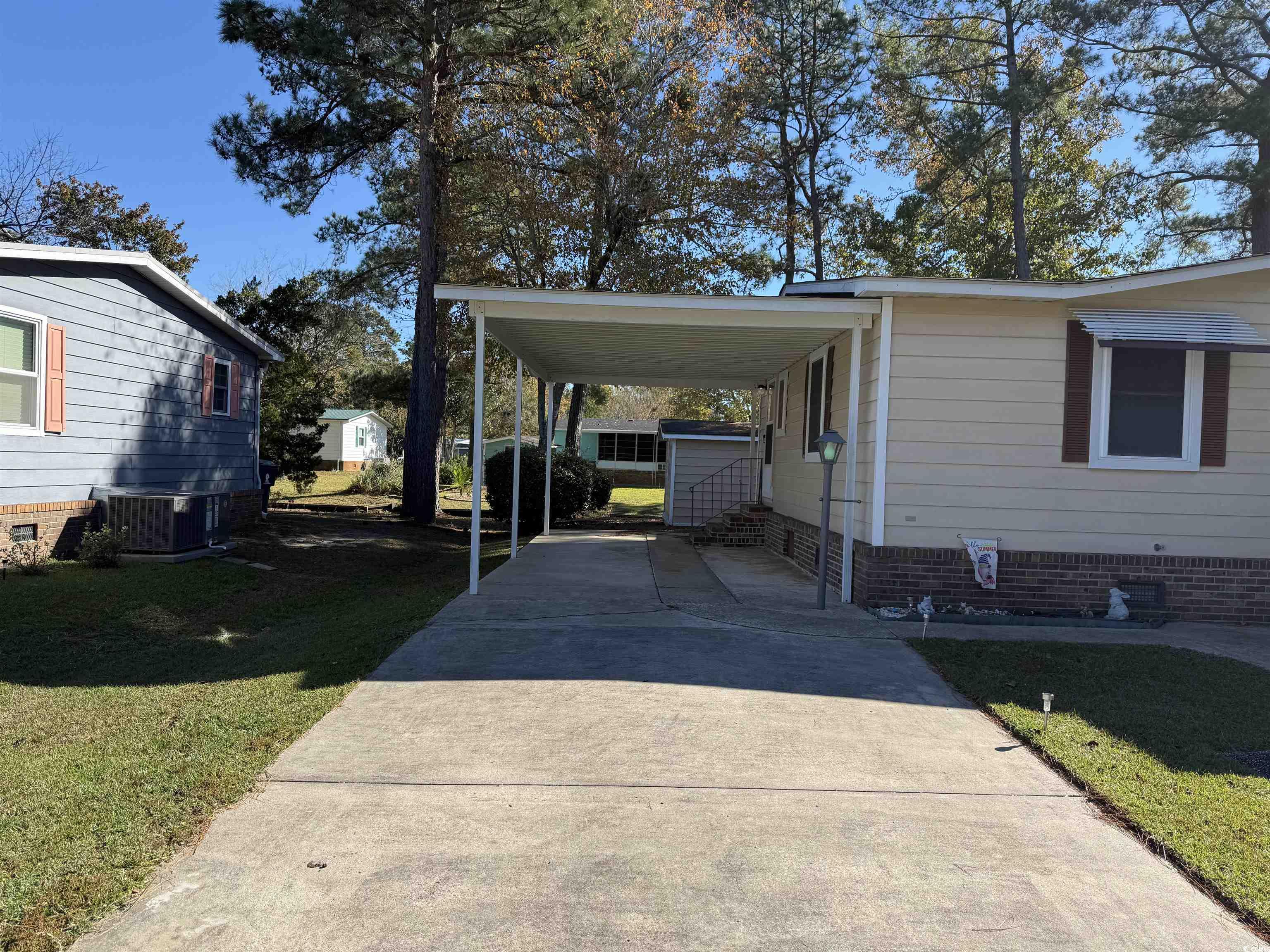3255 Pecan Trail Murrells Inlet, SC 29576 - Photo 4 of 35 View of vehicle parking with a lawn and a carport