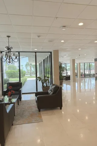 a living room with fireplace furniture and a floor to ceiling window