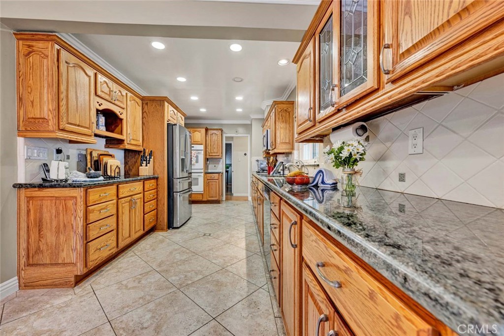 5456 Cadbury Road Whittier, CA 90601 - Photo 12 of 67 a kitchen with stainless steel appliances granite countertop a sink and cabinets
