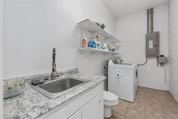 a utility room with wooden floor washer and dryer