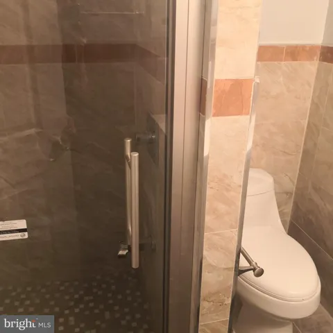 a bathroom with a toilet and a shower