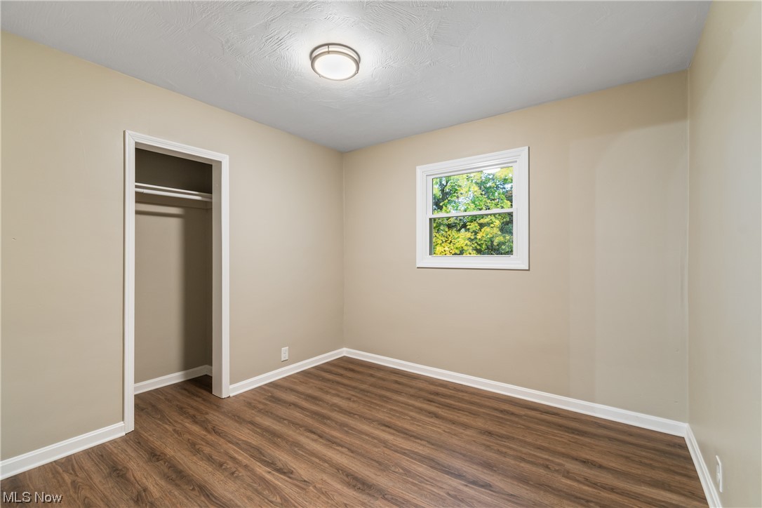 916 Renninger Road Akron, OH 44319 - Photo 19 of 31 Unfurnished bedroom with a closet and dark hardwood / wood-style flooring