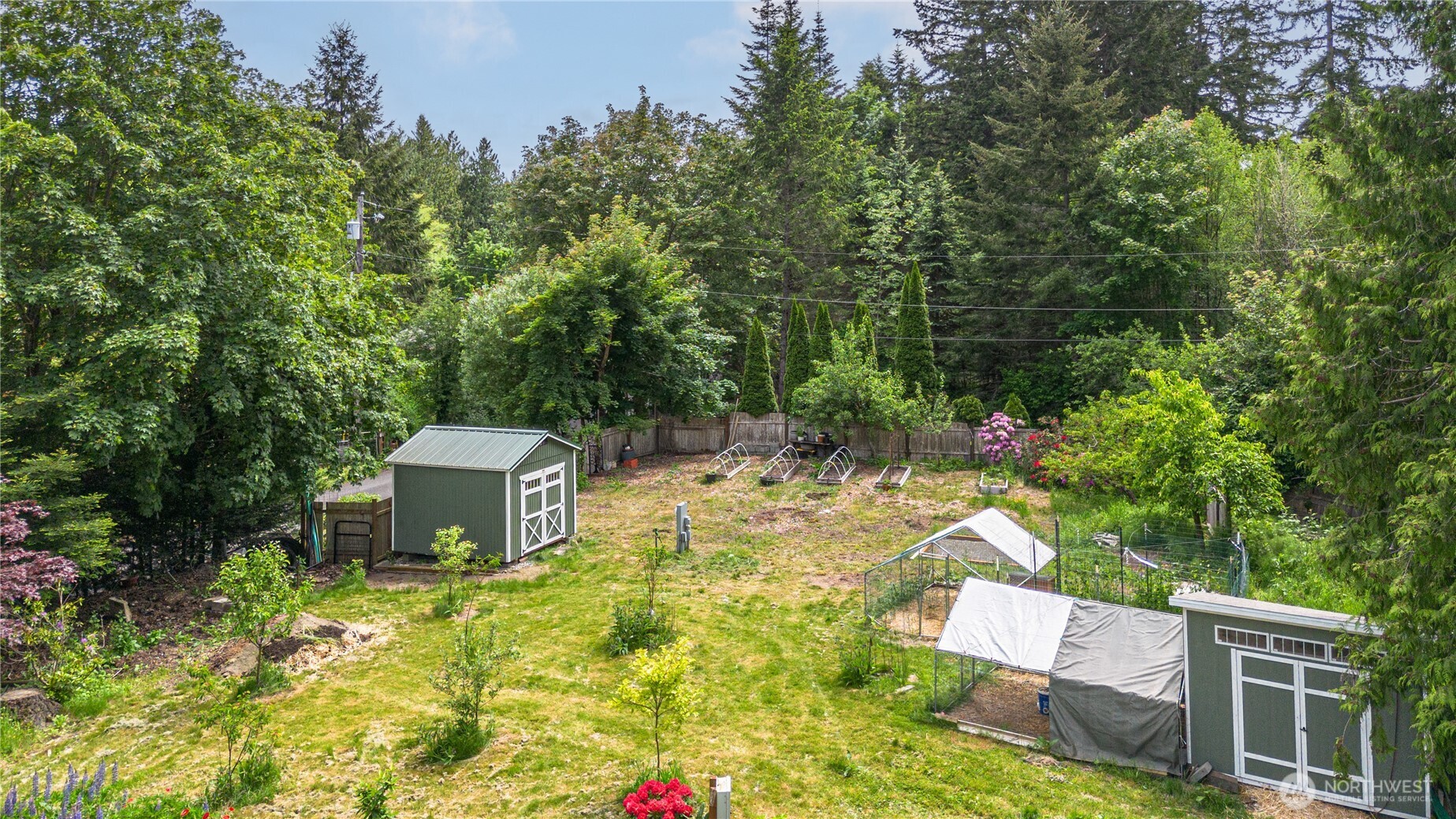 290 Werner Road Port Ludlow, WA 98365 - Photo 26 of 40 a view of a backyard with table and chairs and plants