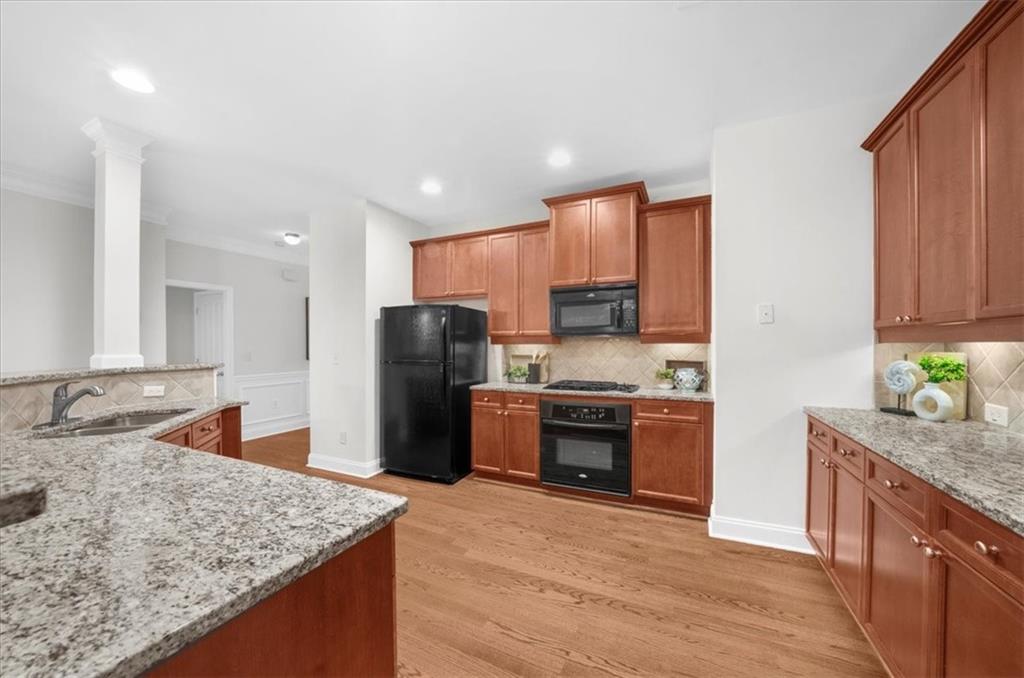 2426 Strand Avenue Lawrenceville, GA 30043 - Photo 8 of 30 a kitchen with stainless steel appliances granite countertop a sink stove and refrigerator