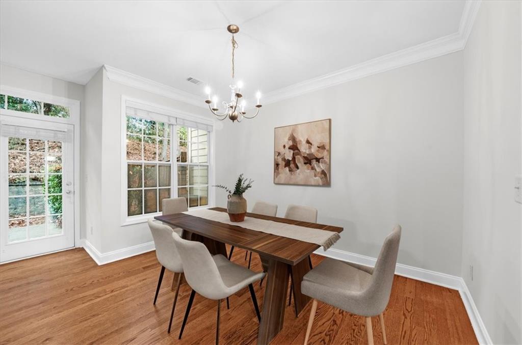 2426 Strand Avenue Lawrenceville, GA 30043 - Photo 9 of 30 a view of a dining room with furniture wooden floor and chandelier