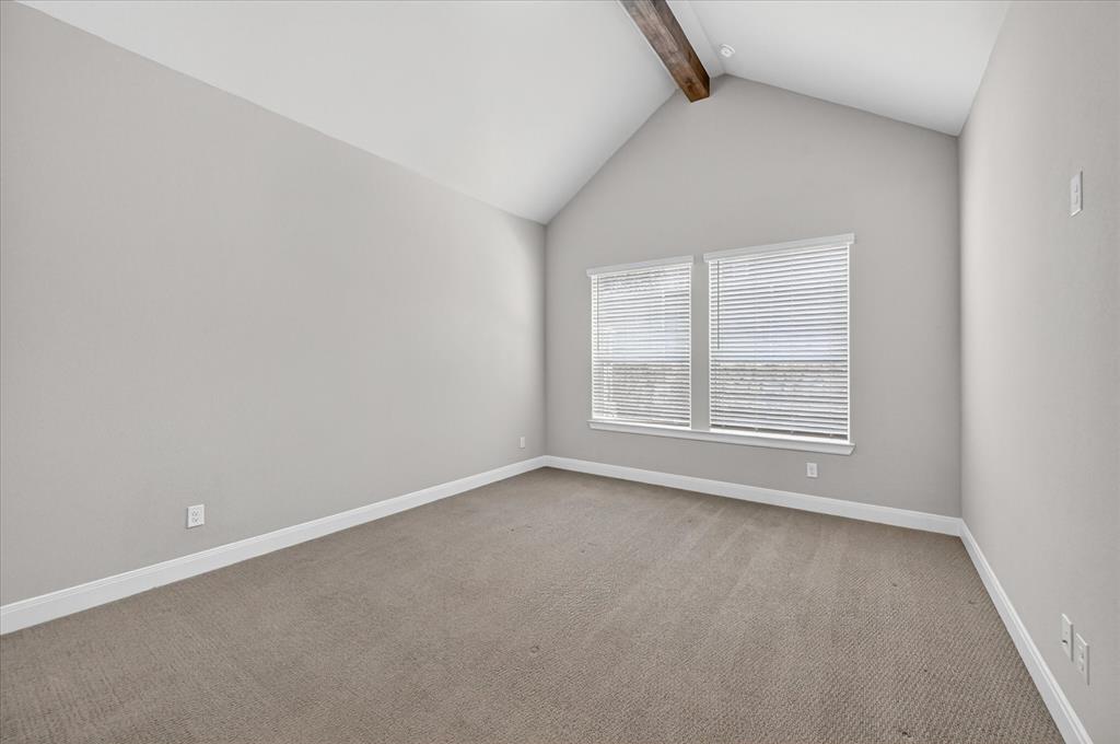 2237 Pika Road Northlake, TX 76247 - Photo 16 of 37 Vaulted ceiling with an exposed wood beam, two windows with blinds, light gray wall paint, white trim, and neutral-toned carpet flooring