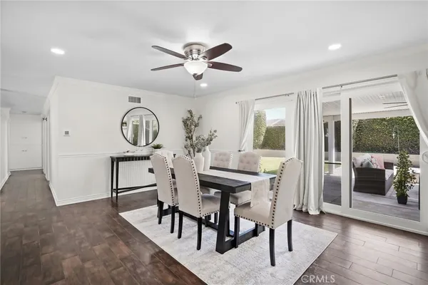 a view of a dining room with furniture and wooden floor