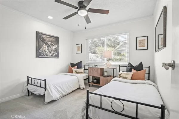 a spacious bedroom with a bed and a chandelier