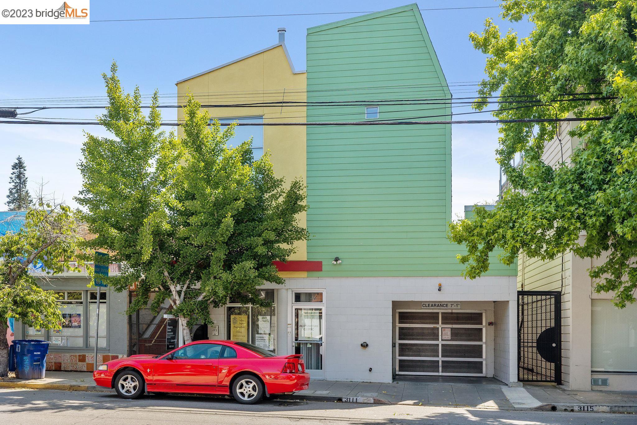 a yellow and red car parked in front of a building