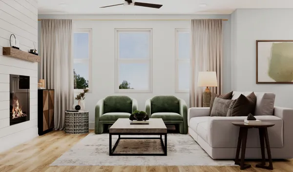 a living room with furniture and a potted plant