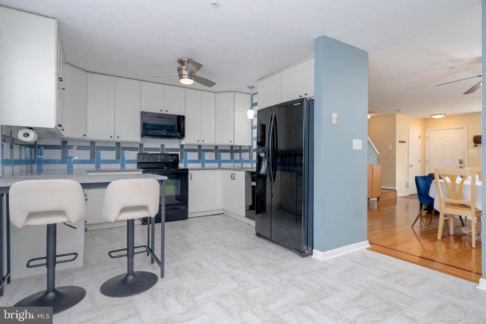 540 Doefield Court Abingdon, MD 21009 - Photo 15 of 48 a kitchen with stainless steel appliances kitchen island granite countertop a table and chairs in it