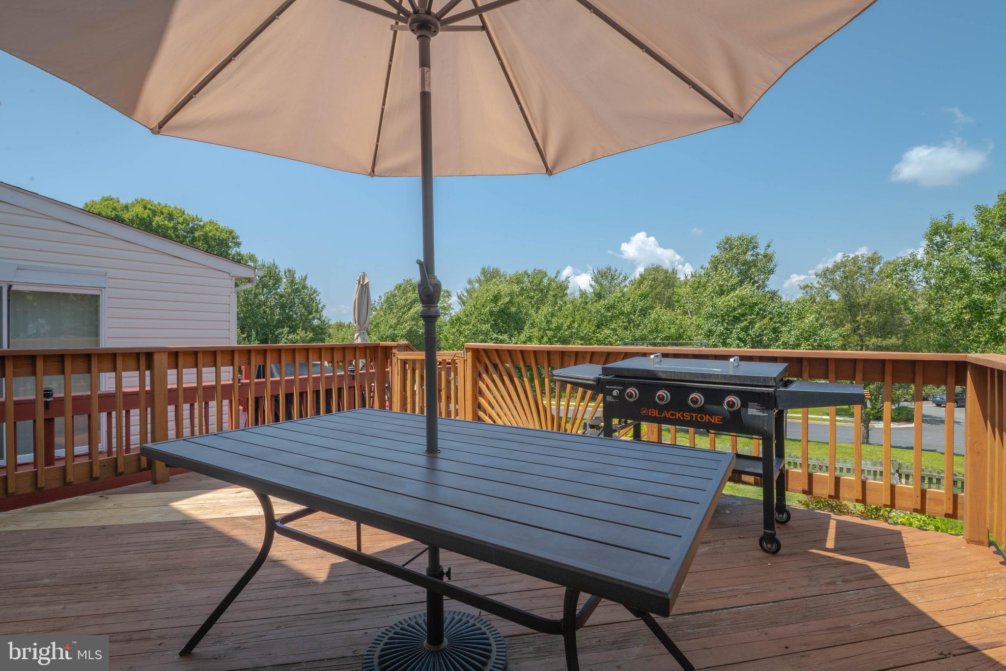 540 Doefield Court Abingdon, MD 21009 - Photo 46 of 48 a view of deck with dinning table and chair under an umbrella