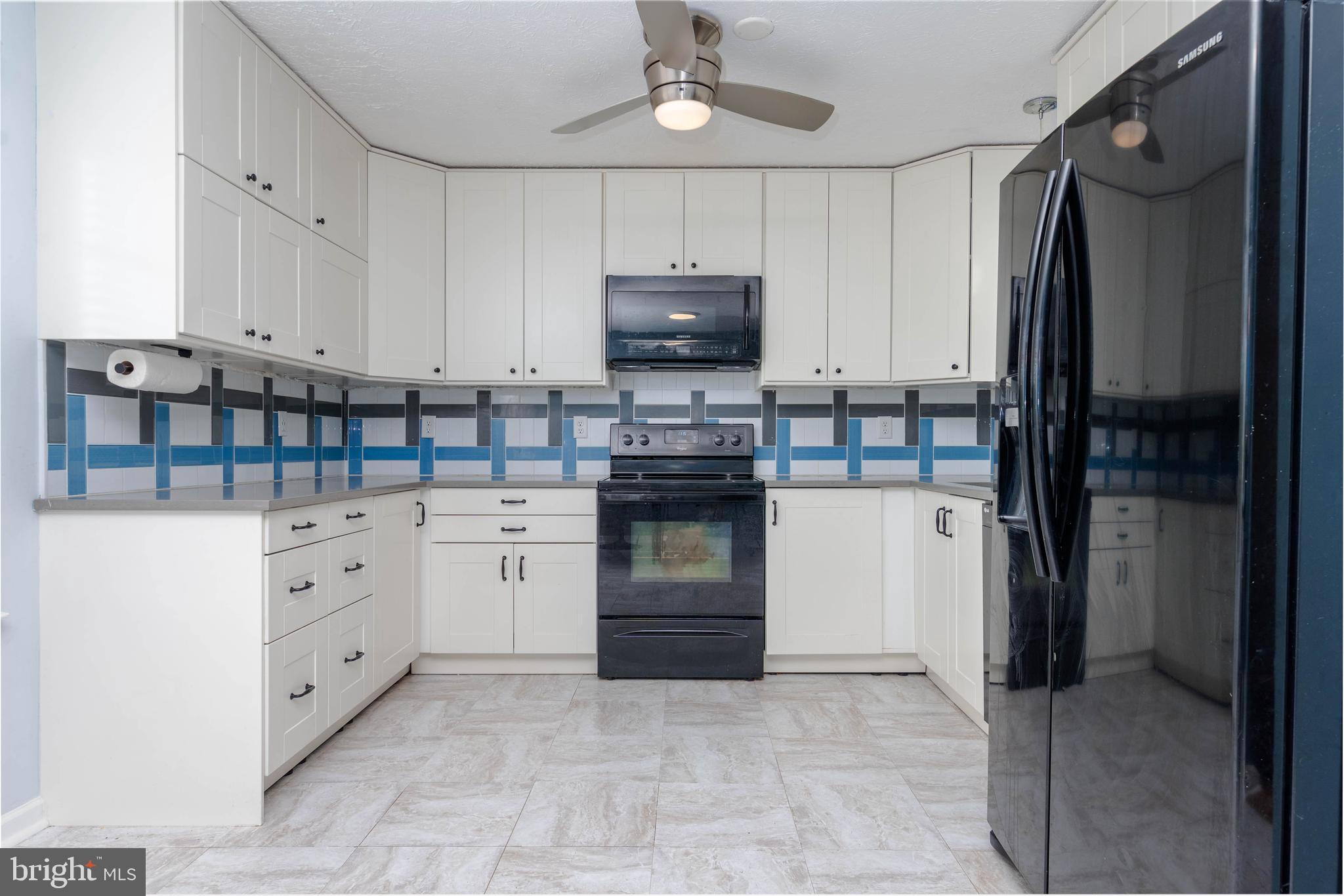 540 Doefield Court Abingdon, MD 21009 - Photo 9 of 48 a kitchen with white cabinets and refrigerator
