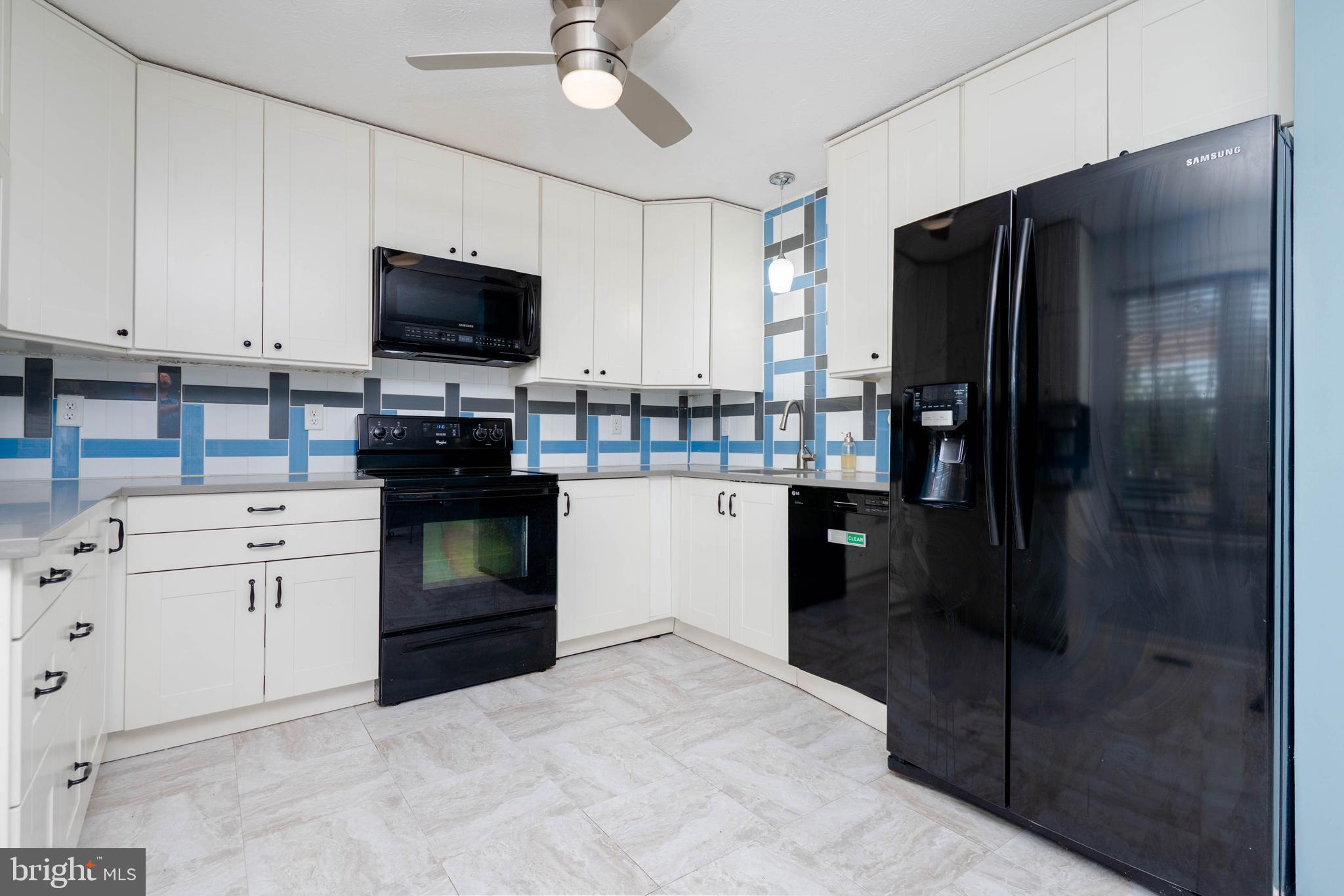 540 Doefield Court Abingdon, MD 21009 - Photo 10 of 48 a kitchen with a refrigerator stove and white cabinets