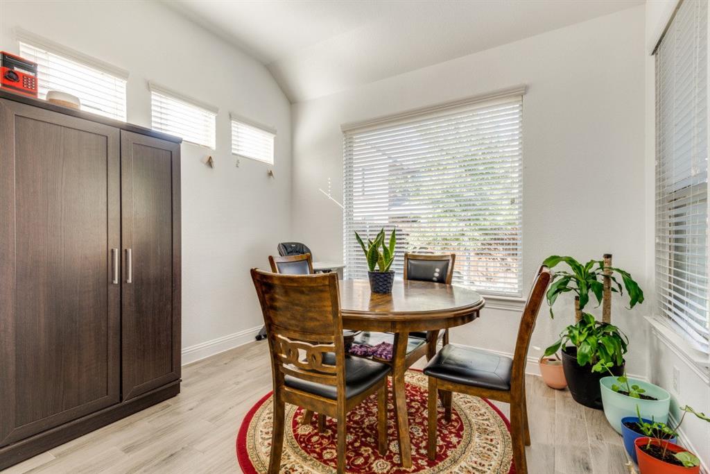 10312 Georgetown Place McKinney, TX 75071 - Photo 12 of 25 a dining room with furniture potted plants and wooden floor