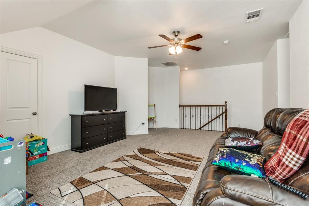 10312 Georgetown Place McKinney, TX 75071 - Photo 13 of 25 a bedroom with a bed and a flat screen tv