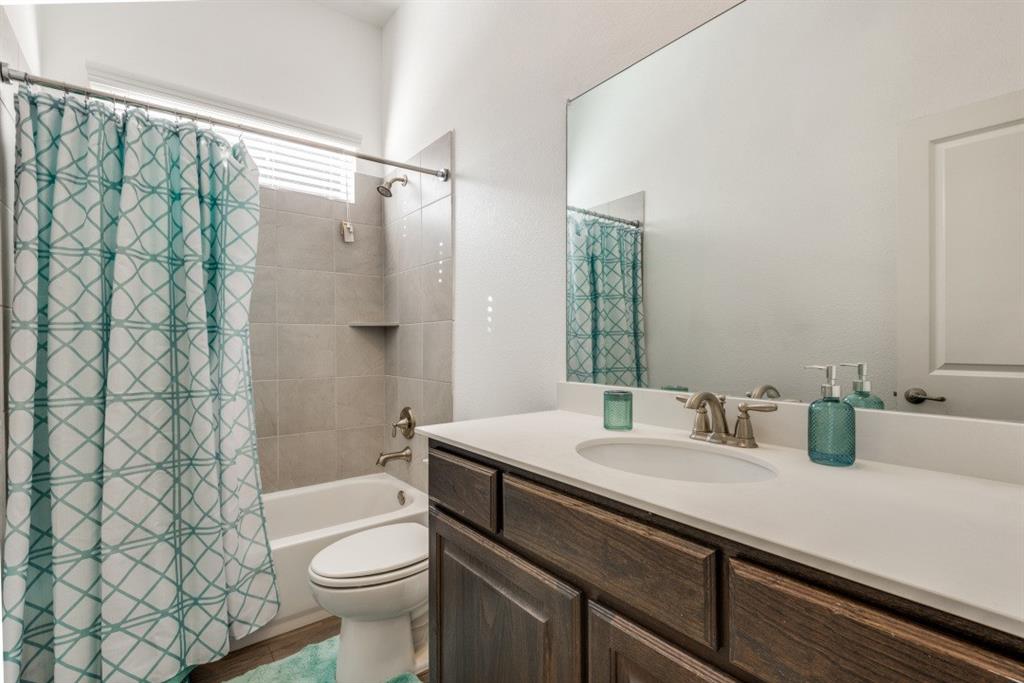 10312 Georgetown Place McKinney, TX 75071 - Photo 19 of 25 a bathroom with a sink a toilet and shower