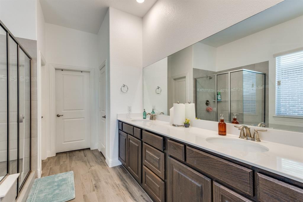 10312 Georgetown Place McKinney, TX 75071 - Photo 24 of 25 a bathroom with a sink double vanity granite tub shower and a mirror