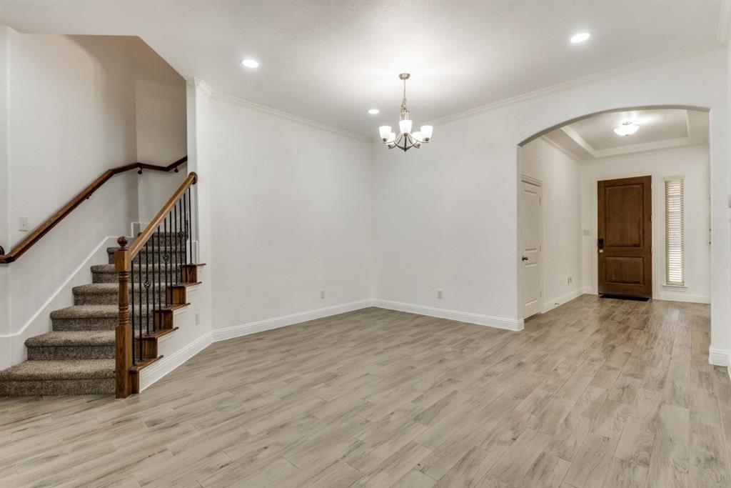10312 Georgetown Place McKinney, TX 75071 - Photo 3 of 25 an empty room with wooden floor and staircase
