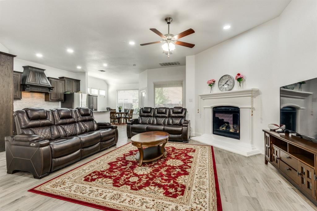 10312 Georgetown Place McKinney, TX 75071 - Photo 7 of 25 a living room with furniture and a fireplace