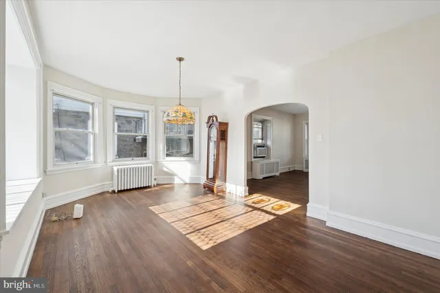 a view of a living room with wooden floor and a window